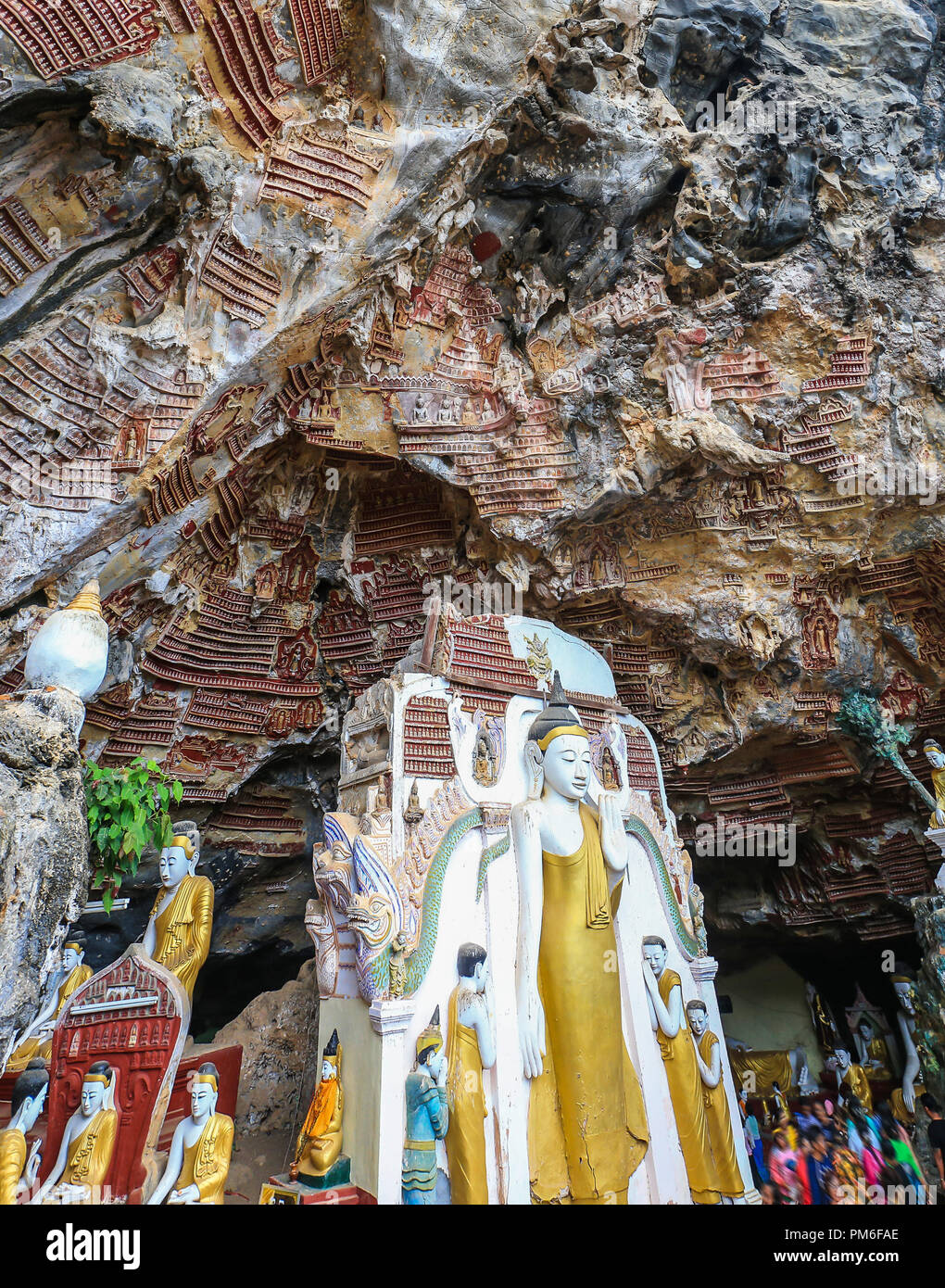 Religious carvings on limestone rock in sacred Kaw Goon cave near Hpa-An in Myanmar (Burma) Stock Photo