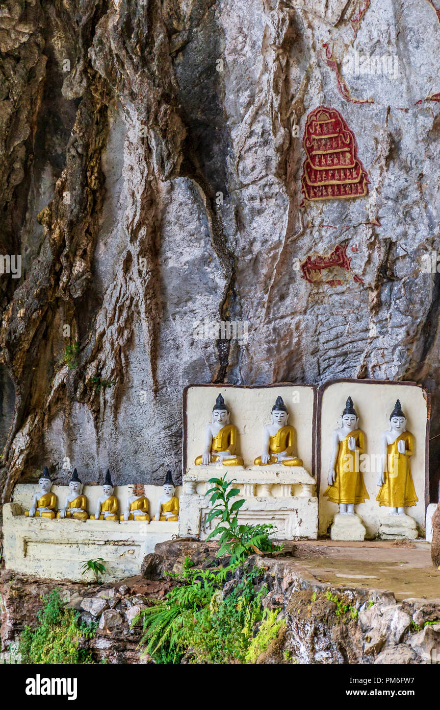 Religious carvings on limestone rock in sacred Kaw Goon cave near Hpa-An in Myanmar (Burma) Stock Photo