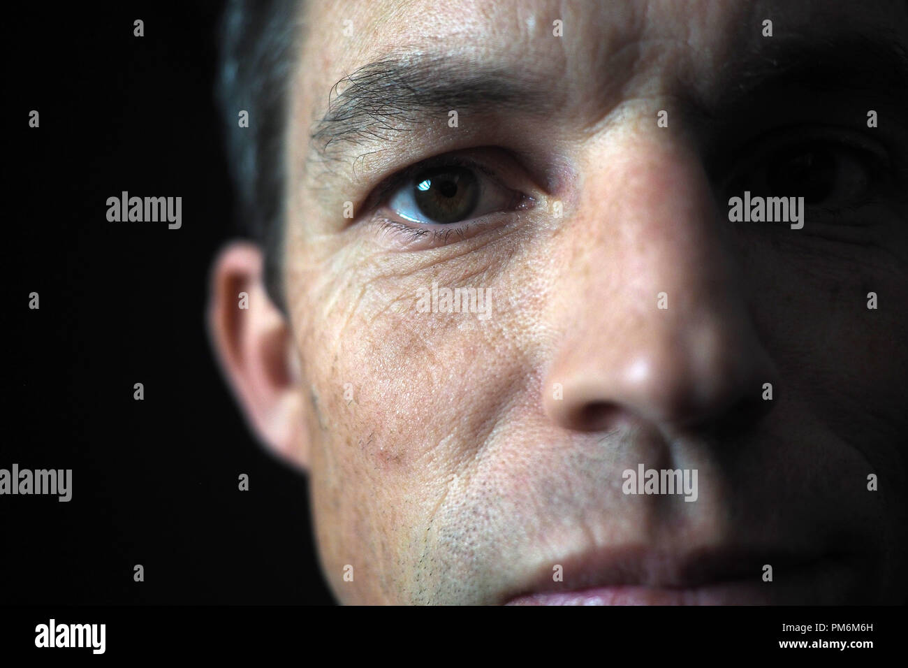 Portrait of man on black background, close up on eye Stock Photo