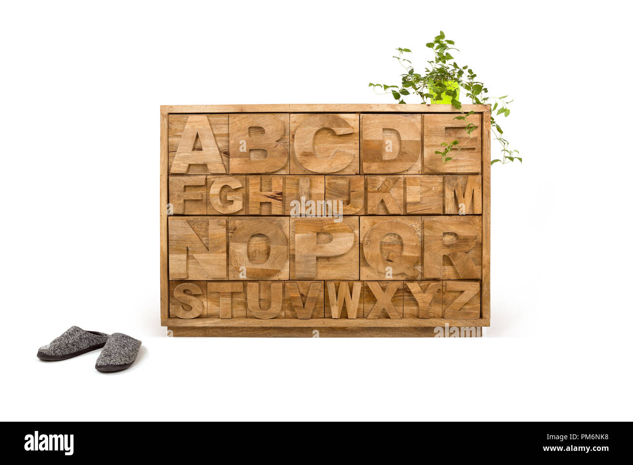 Wooden Drawer With Flowerpot And Green Plant And Slippers Isolated