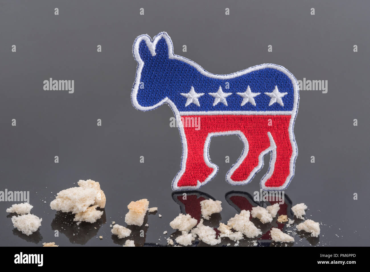 US Democrat donkey & breadcrumbs - in reference to Speaker Nancy Pelosi's comment on Trump employee bonuses being mere 'crumbs' & Jan 6th blame trail Stock Photo