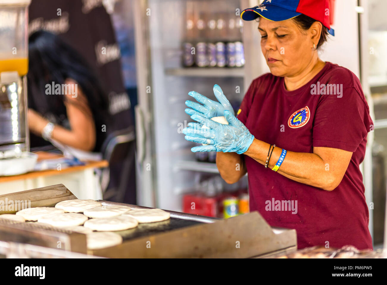 https://c8.alamy.com/comp/PM6PW5/cervia-ra-italy-september-16-2018-woman-preparing-venezuelan-arepas-for-sale-at-european-market-street-exhibition-of-typical-products-and-flav-PM6PW5.jpg