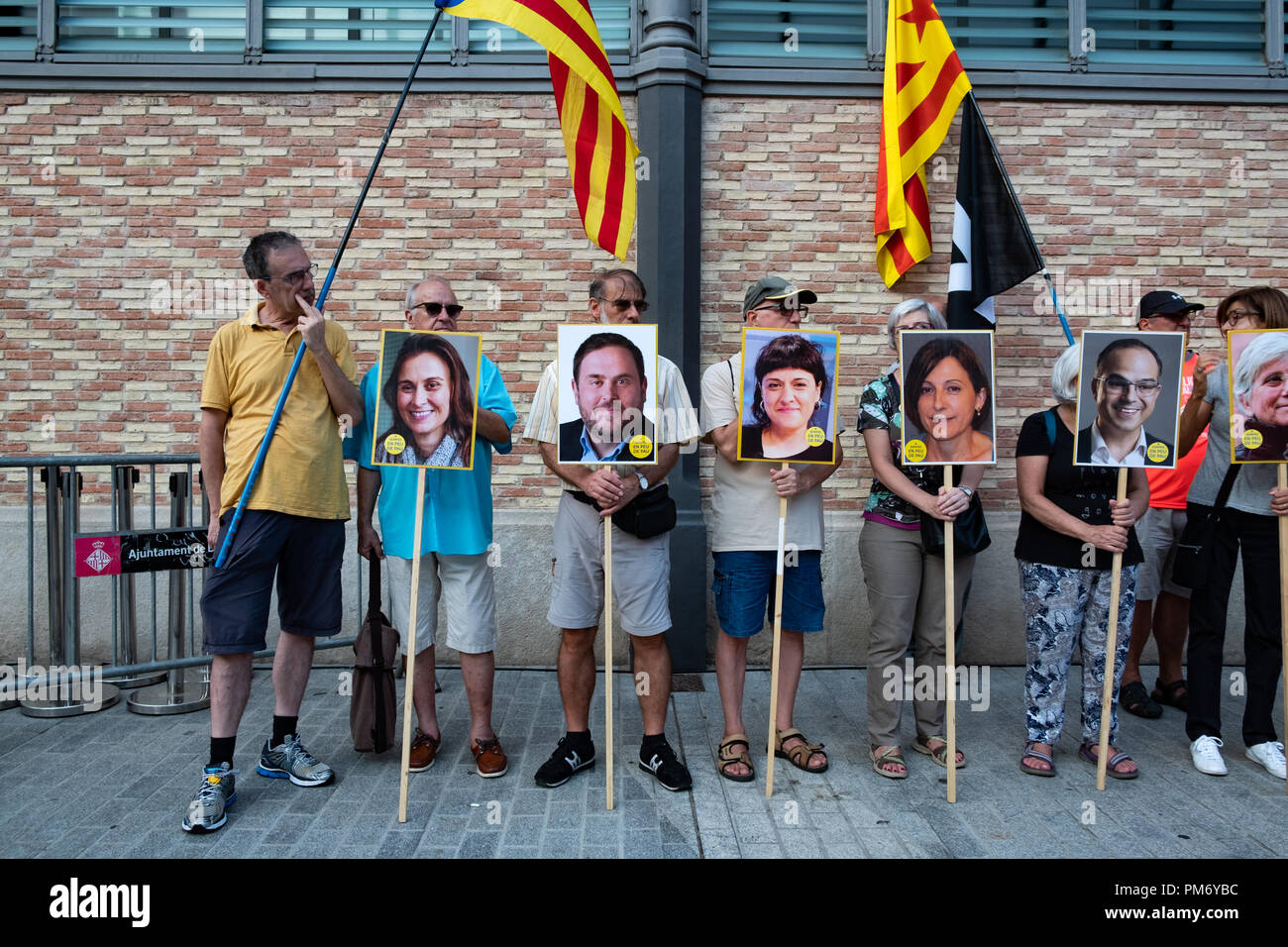 Several pro-independence supporters are seen with photos of Catalan political prisoners during a demonstration convened by the main sovereign entities of Catalonia, Assemblea and Òmnium, independent supporters sent letters to Catalan political prisoners as a way of reminding the public of their plight. Stock Photo