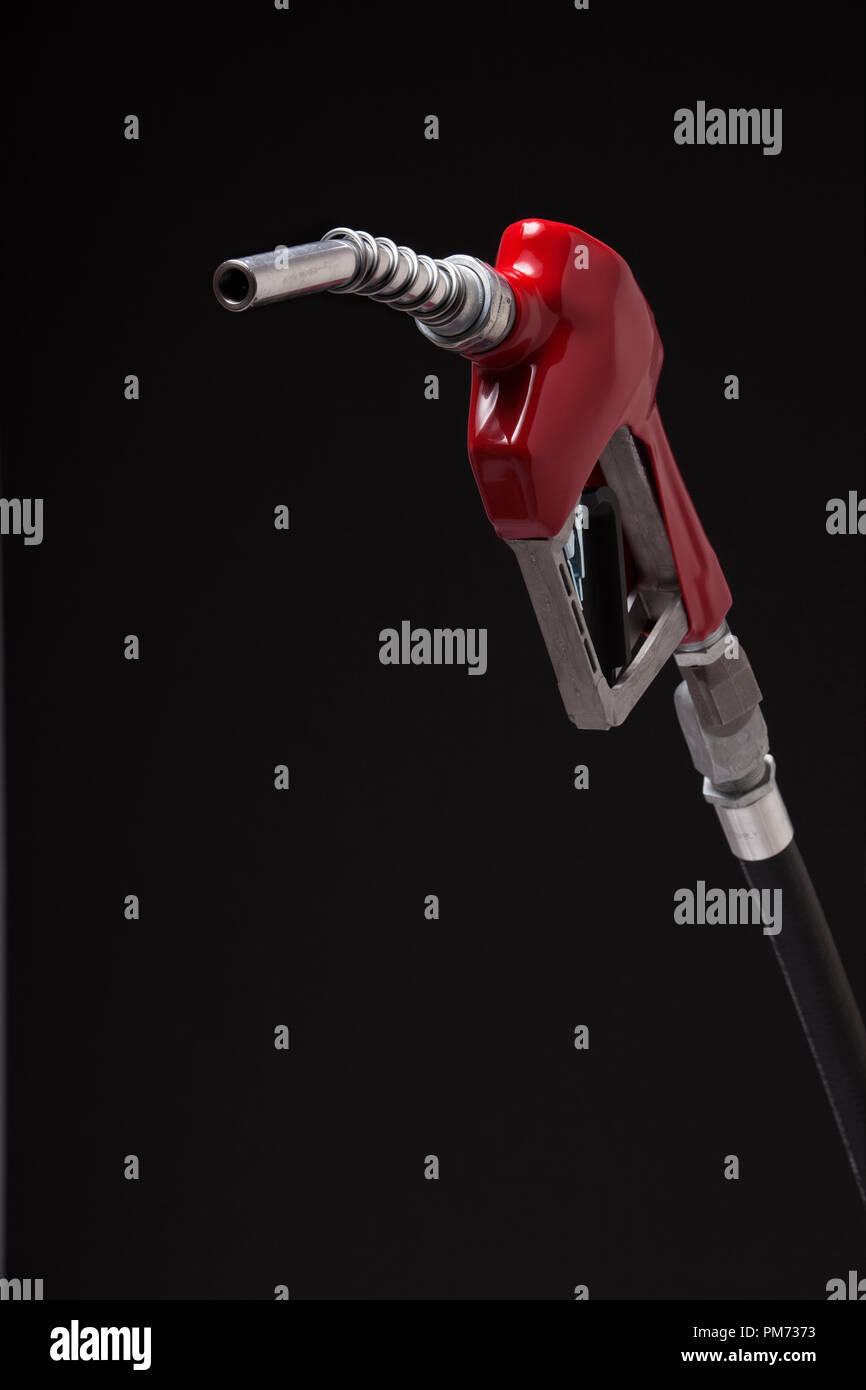 A gasoline pump nozzle with a red vinyl covered handle isolated on black Stock Photo