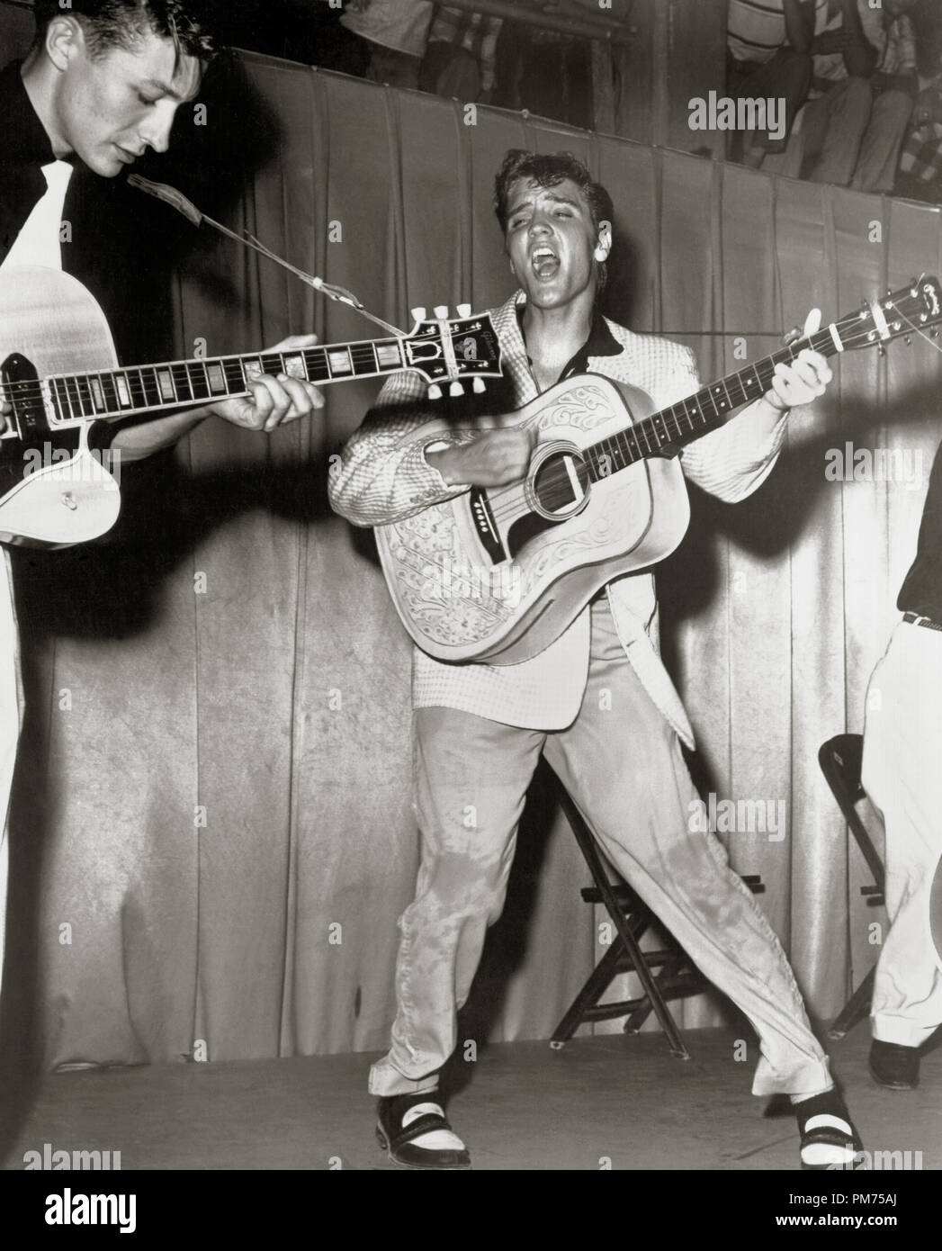 Publicity photo of Elvis Presley at a concert in Fort Homer Hesterly Armory in Tampa, Florida, July 31,1955. Left Scotty Moore, Right Bill Black. Photo by William V. (Red) Robertson File Reference # 30928 455THA Stock Photo