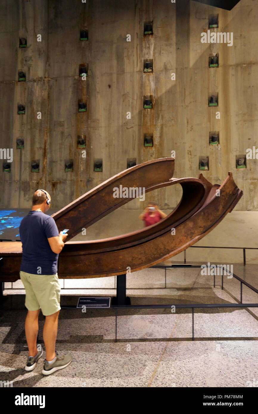 A visitor in front of destroyed steel column from Twin Towers in National 9/11 Memorial & Museum.New York City.USA Stock Photo