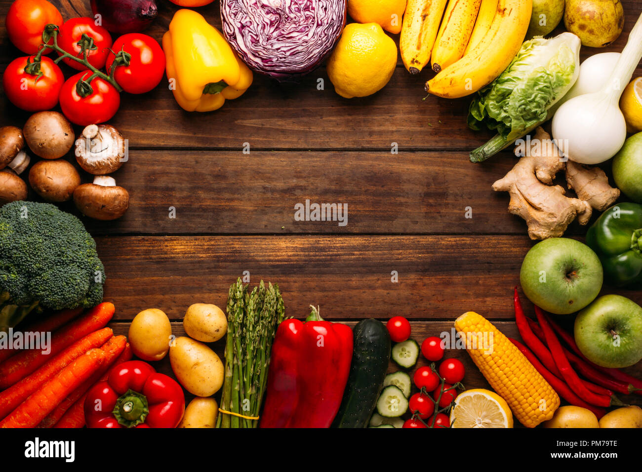 Top view of a wooden table full of fresh vegetables and fruits Stock Photo