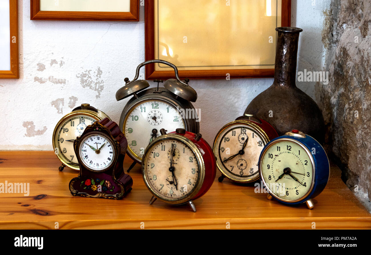 Group of old vintage alarm clocks on table in studio in Jaffa, Tel Aviv, Israel Stock Photo