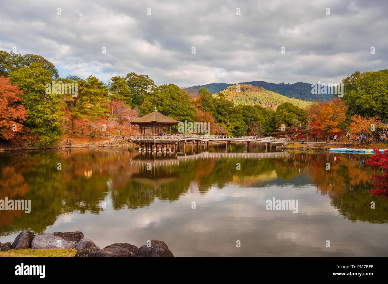 Scenic view of Nara public park in autumn, with pond and old pavilion, in Japan Stock Photo