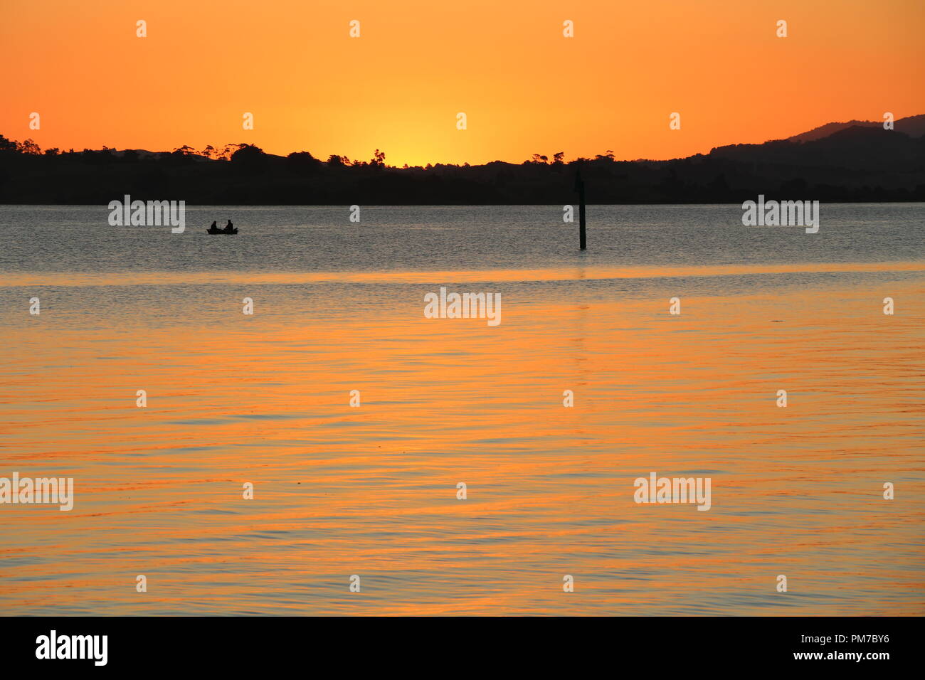 Fisching boat during sunset at Jacksons Bay - New Zealand Stock Photo