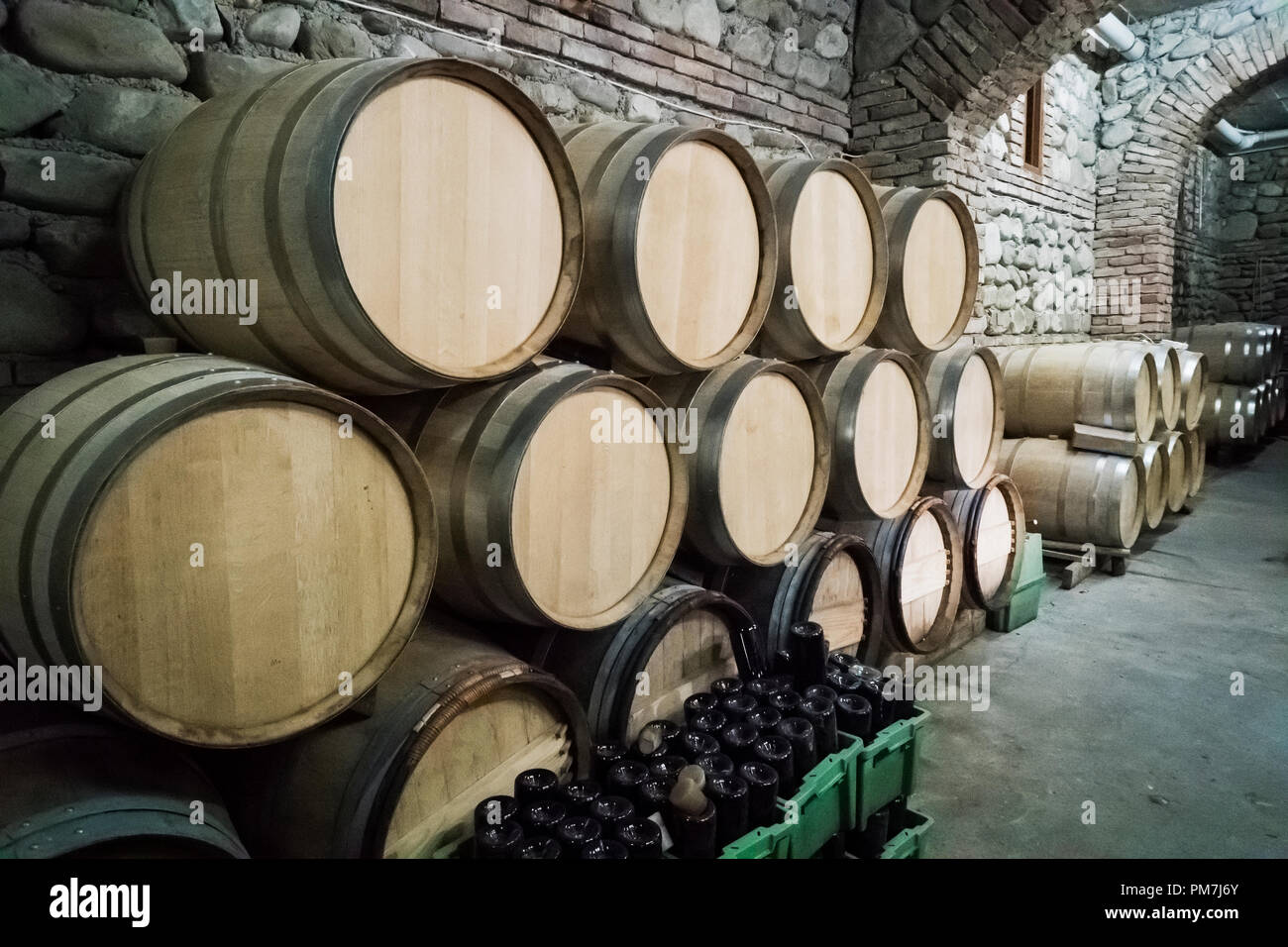 Wine barrels stacked in the old cellar of the winery Stock Photo - Alamy