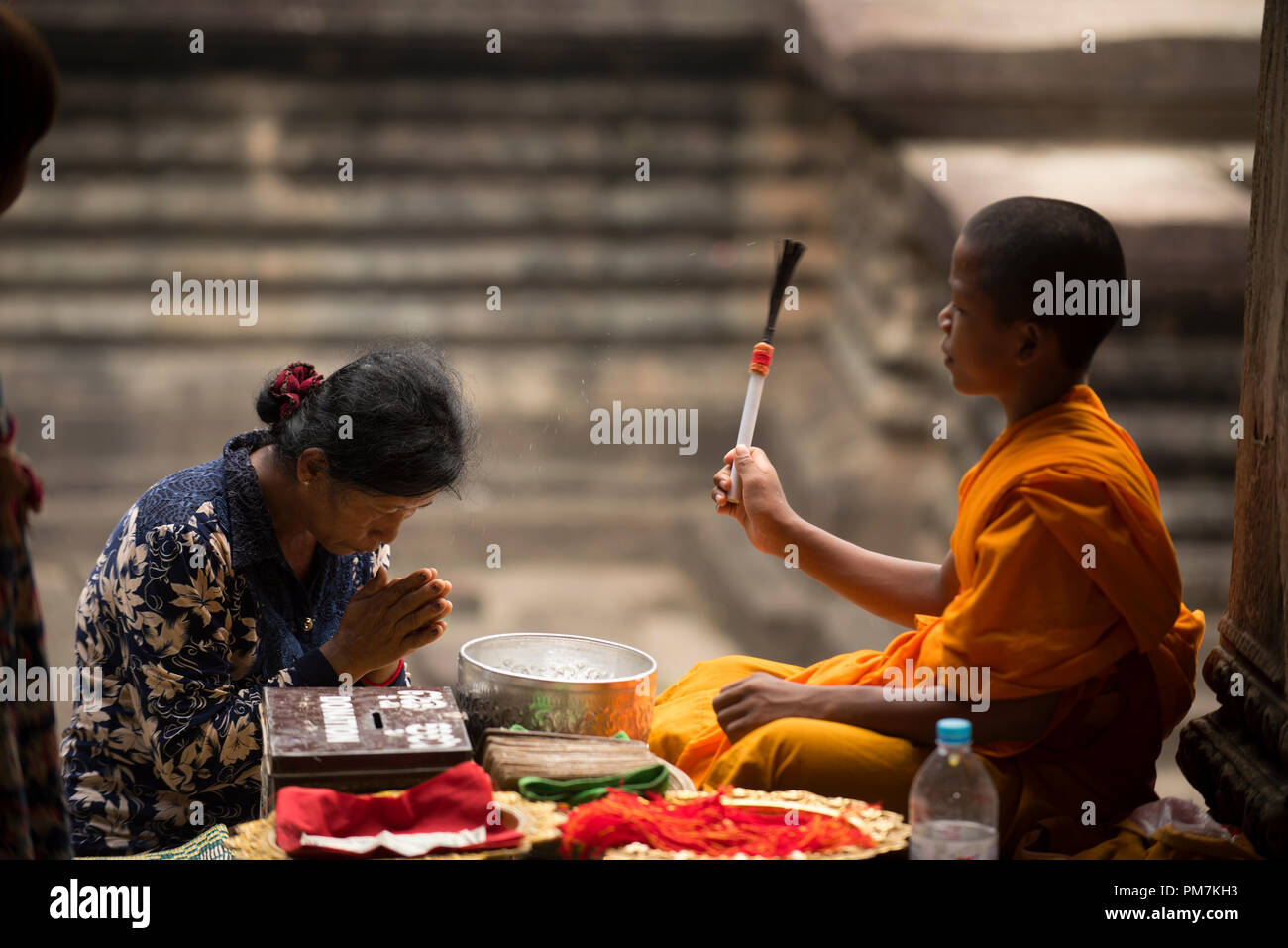 Cambodia, Siem Raep; Angkor Vat, Old woman blessed by a young monk Stock Photo