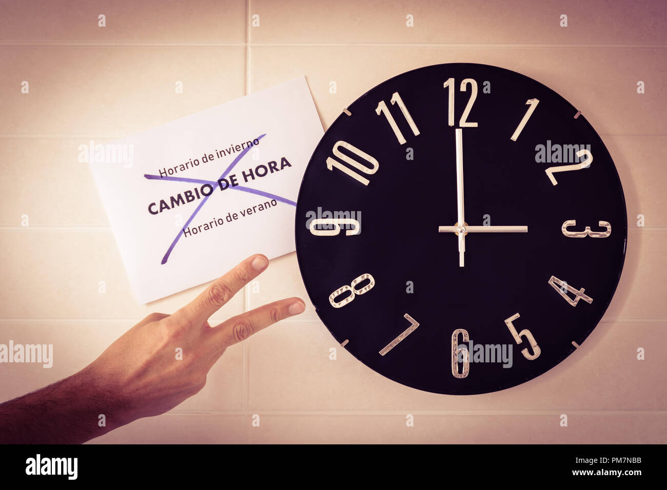 Big black clock on white wall. Time change. DST. Survey of the European