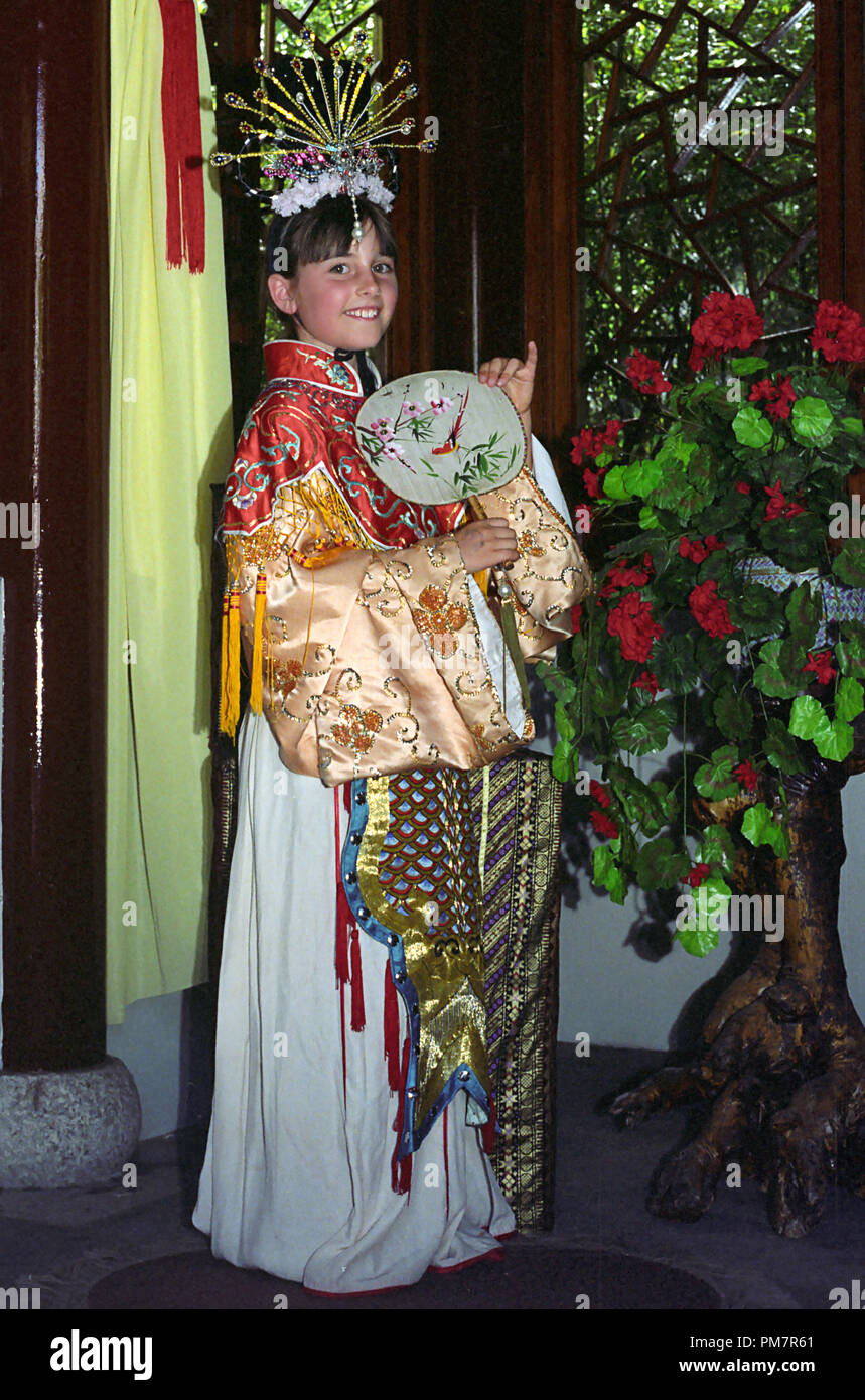 A little girl on her ninth birthday, dressed up in traditional Chinese costume: Chinese Garden of Friendship, Darling Harbour, Sydney, NSW, Australia.  MODEL RELEASED Stock Photo