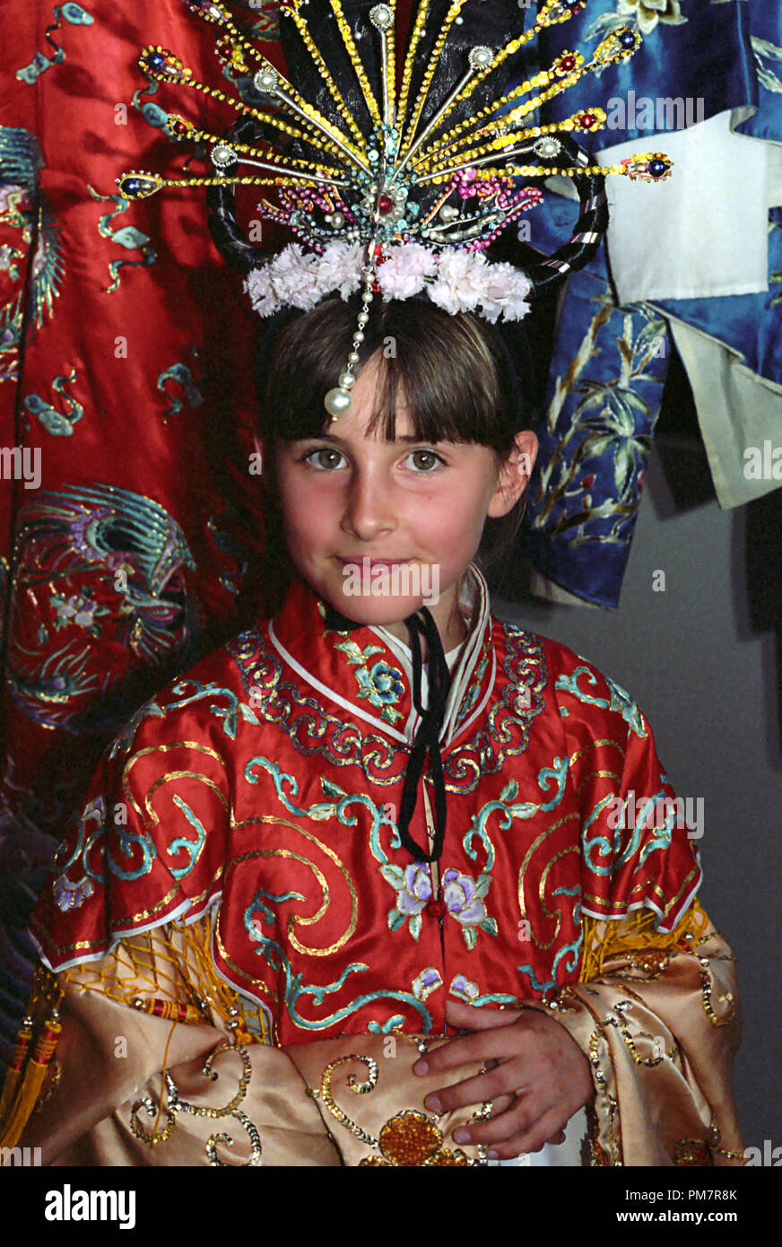 A little girl on her ninth birthday, dressed up in traditional Chinese costume: Chinese Garden of Friendship, Darling Harbour, Sydney, NSW, Australia.  MODEL RELEASED Stock Photo