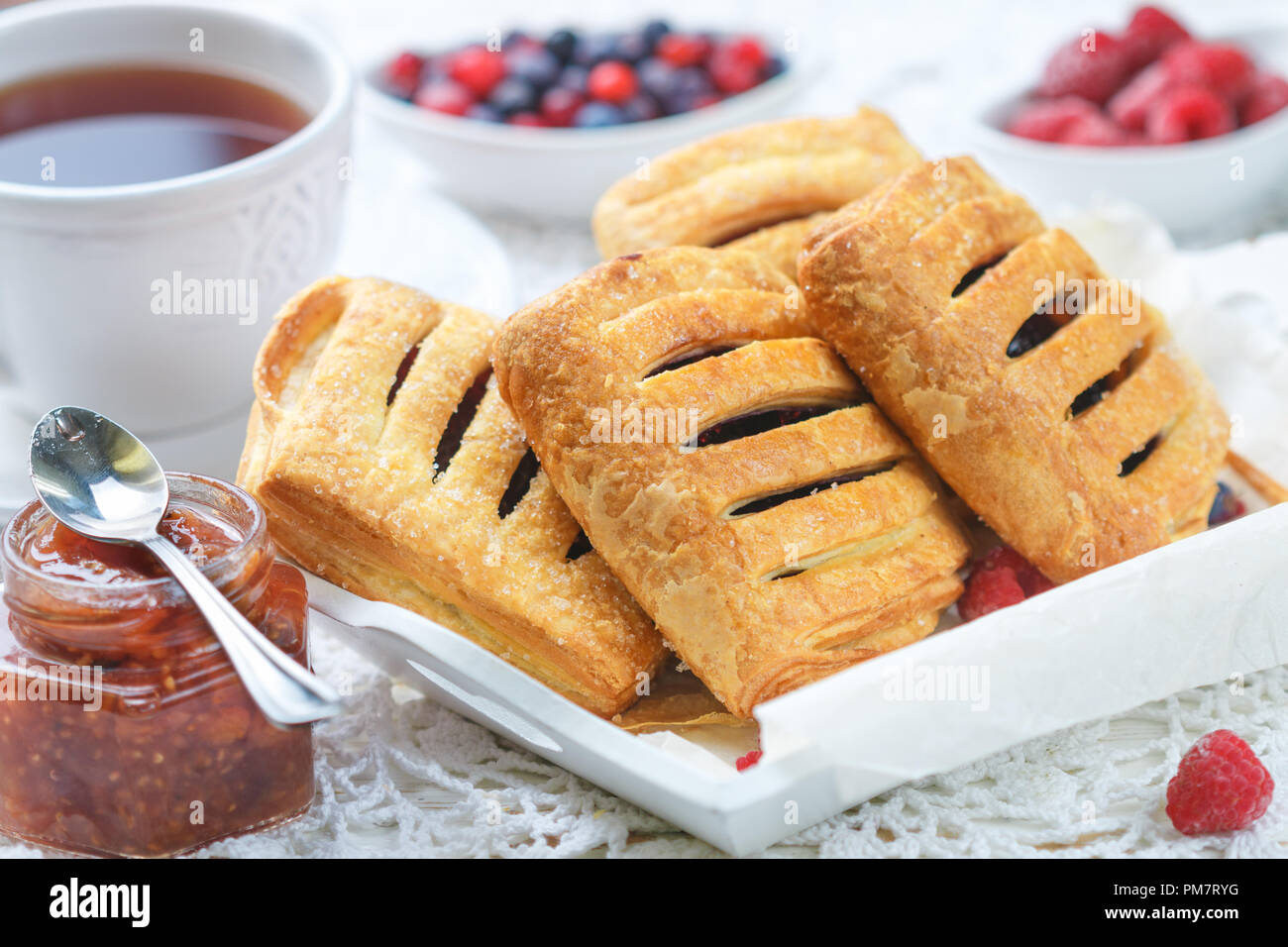 Puff Pastry Raspberry Pie Homemade puff pastry pies with raspberries and blueberries. Selective ...