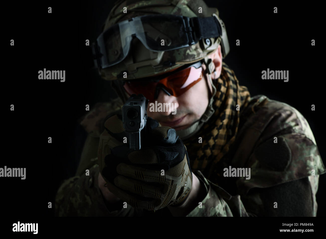 aiming at the camera focus on the muzzle of the gun. close up portrait ...