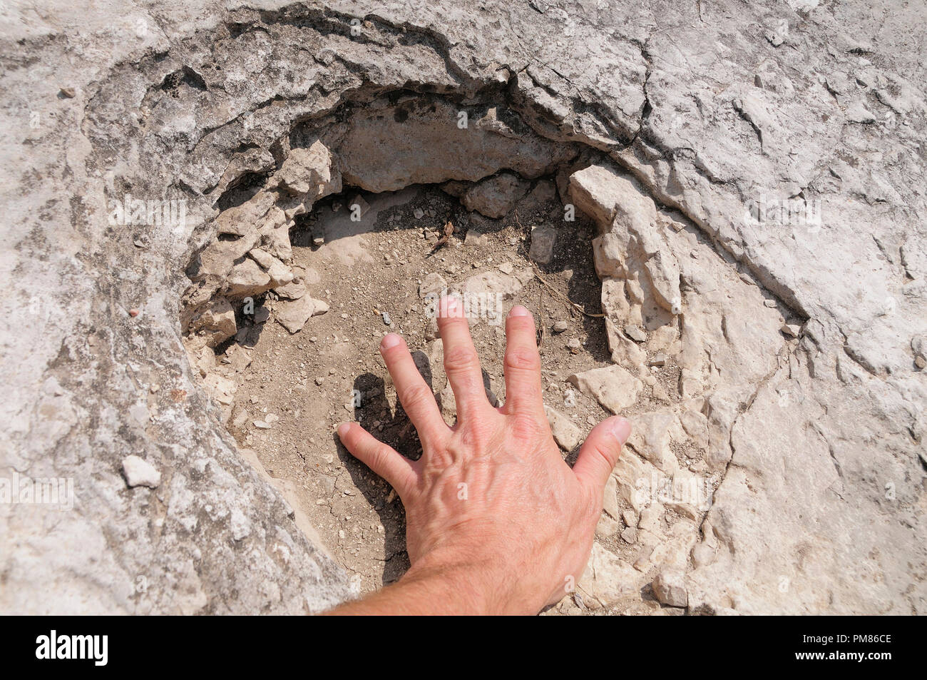 Italy, Trentino Alto Adige, Rovereto, Dinosaur footprint with hand, Piste de Dinosauri. Stock Photo
