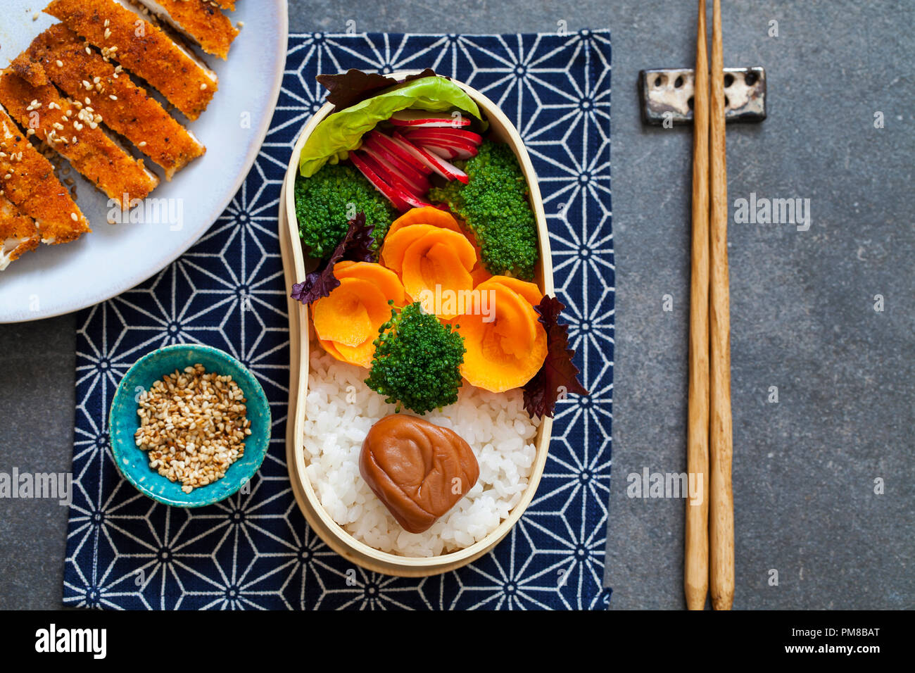 Japanese style lunch with onigiri rice balls and crispy chicken Stock