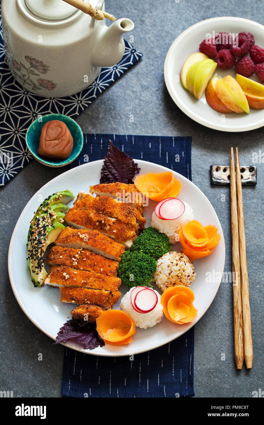 Japanese style lunch with onigiri rice balls and crispy chicken Stock