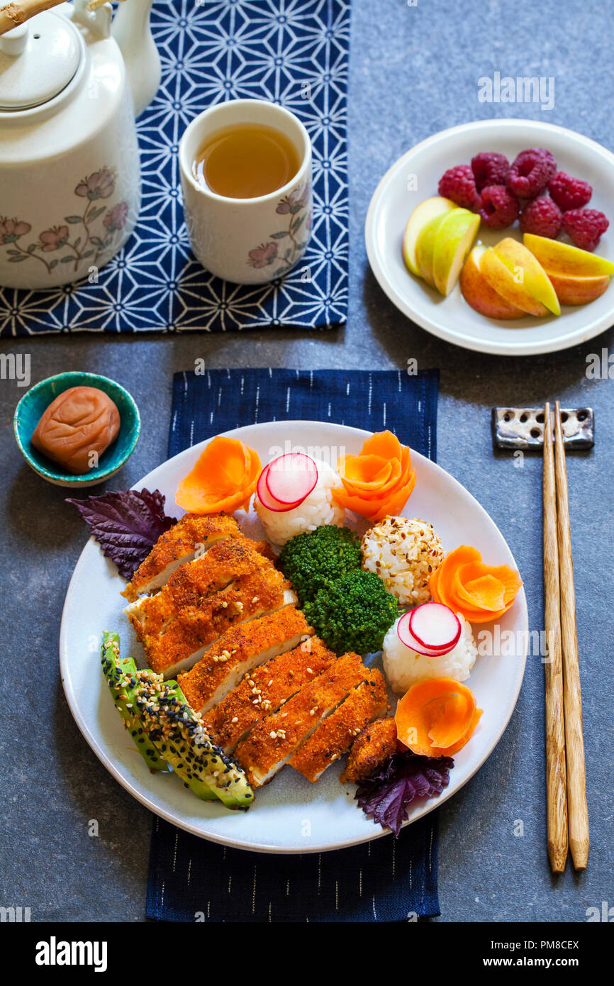 Japanese style lunch with onigiri rice balls and crispy chicken Stock