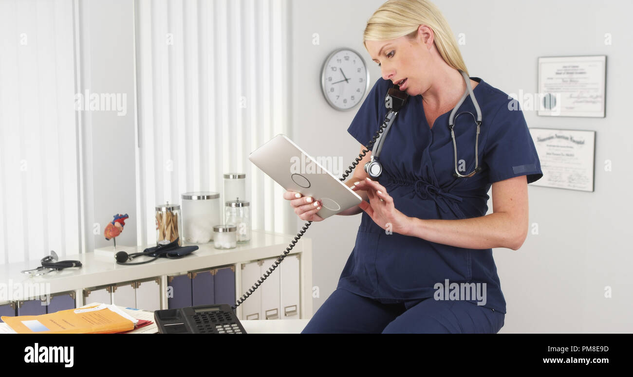Pregnant nurse working in the office Stock Photo Alamy
