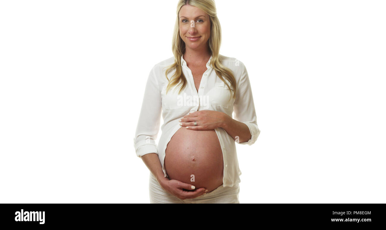 Happy pregnant woman standing and holding belly Stock Photo - Alamy