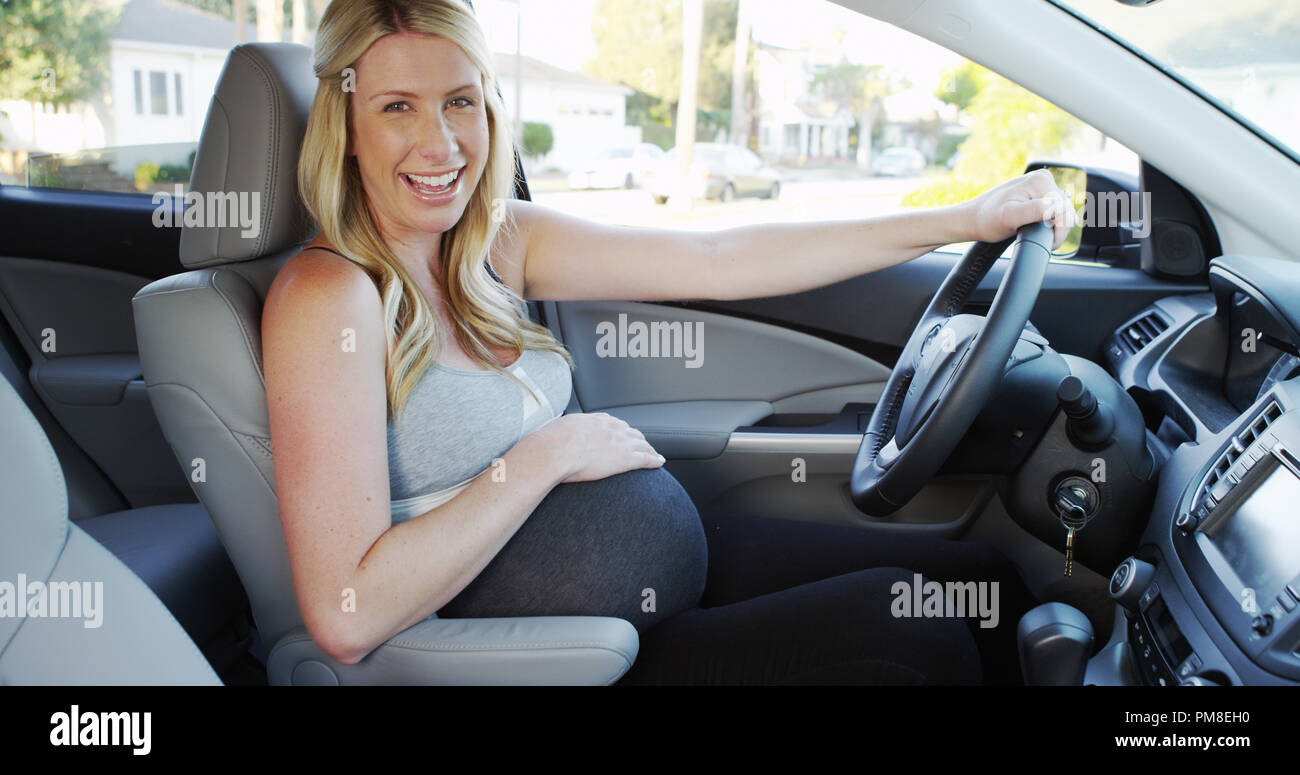 Happy pregnant woman sitting in car smiling Stock Photo Alamy
