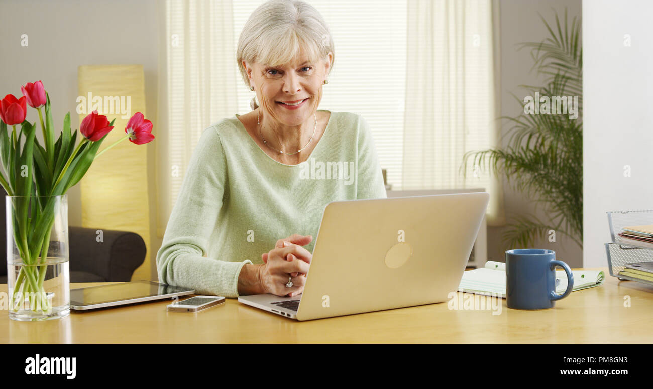 Beautiful senior woman smiling laptop computer Stock Photo - Alamy