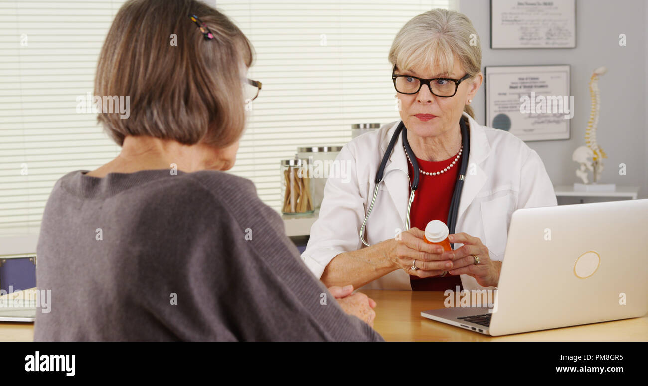 Senior doctor patient giving prescription medication Stock Photo