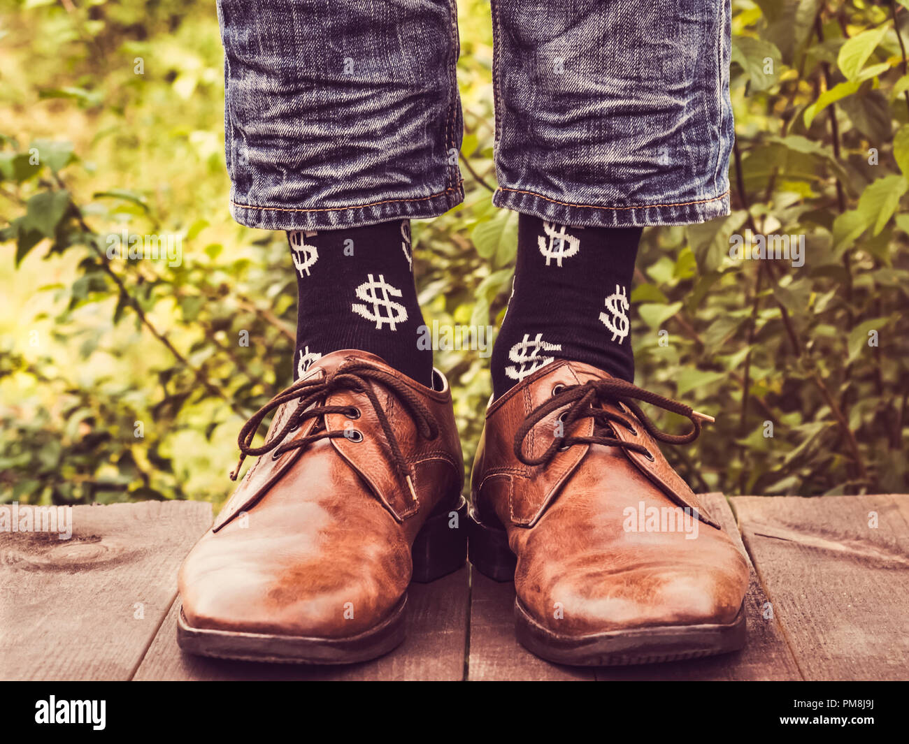Men's legs in stylish shoes, black socks with patterns in the form of US dollars on a wooden terrace against the background of green trees. Beauty, fa Stock Photo - Alamy Men's legs in stylish shoes, black socks with patterns in the form of US dollars on a wooden terrace against the background of green trees. Beauty, fa Stock Photo - Alamy