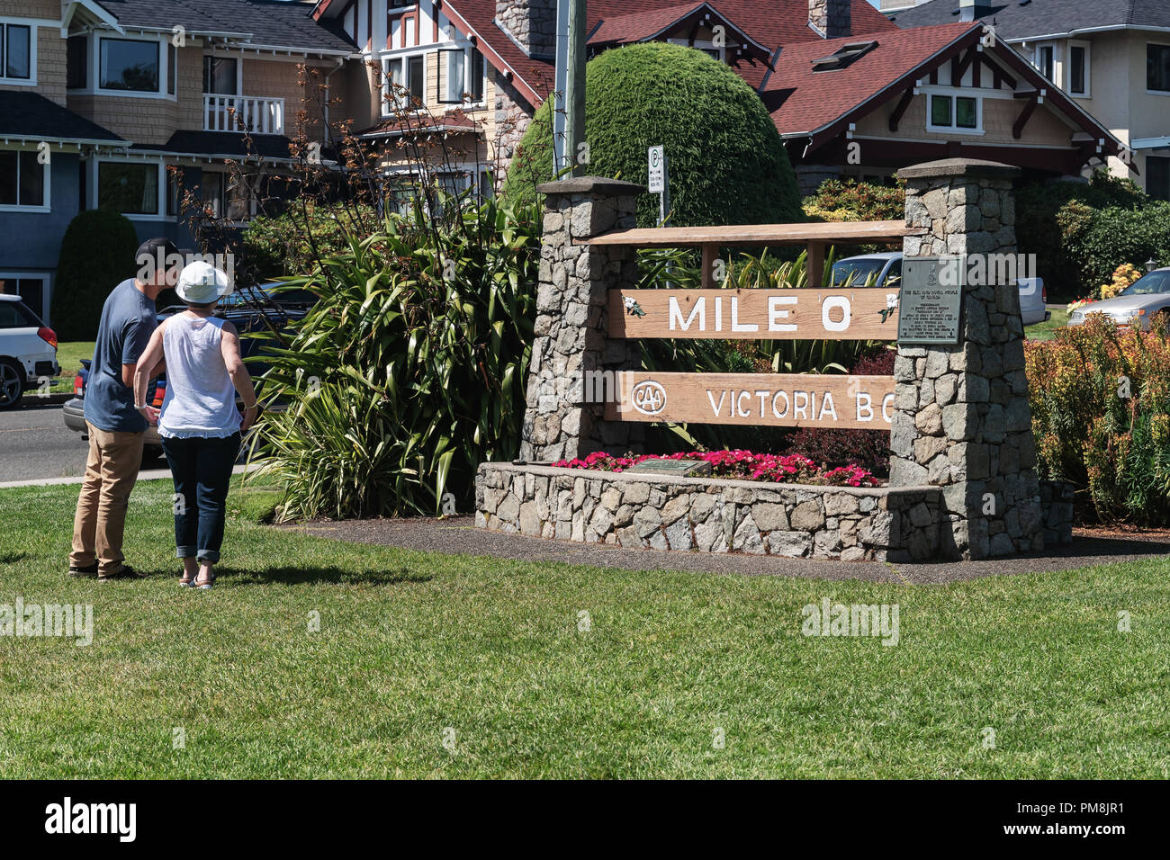 Two Asian tourists near The Mile Zero sign for Canada's TransCanada