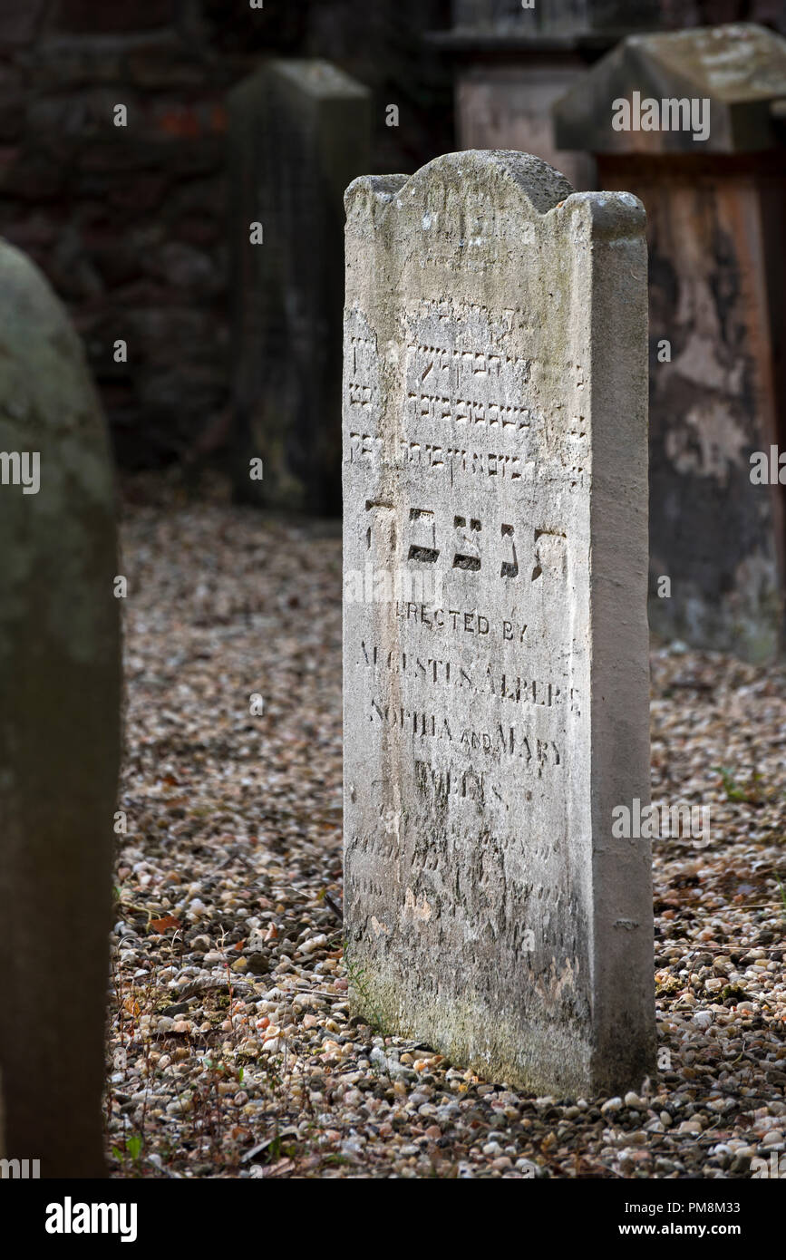 Worn and weathered Jewish headstones in what was the first Jewish Burial Ground in Scotland, opened in 1816. Stock Photo