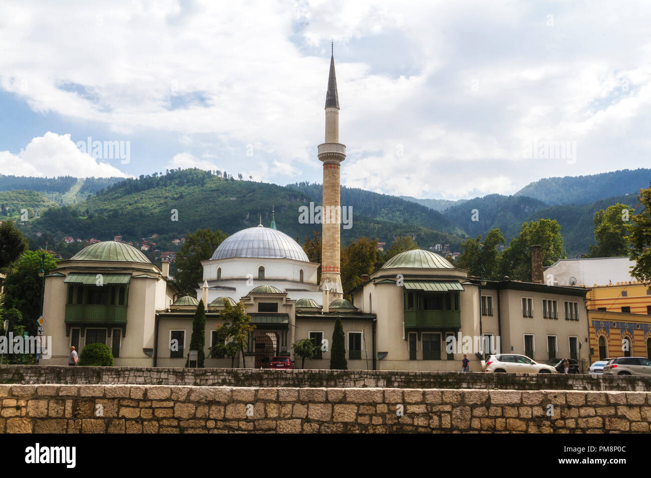 SARAJEVO / BOSNIA AND HERZEGOVINA - September 2, 2018: Outdoor view of Careva Dzamija mosque in Sarajevo on the miljacka riverbank. Stock Photo