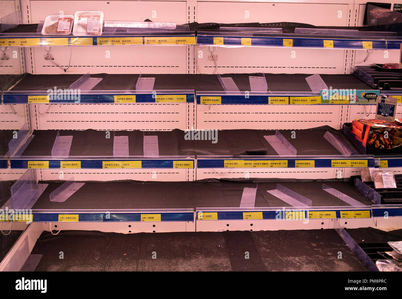 Empty Supermarket meat shelves as residents stock up ahead of Super Typhoon Mangkhut arrival in Hong Kong, China. It is expected to land with a typhoon signal No. 8. Stock Photo