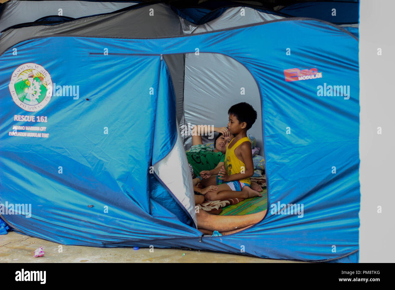 A family staying in the evacuation tents of the Basketball Court of Malanday Marikina City On