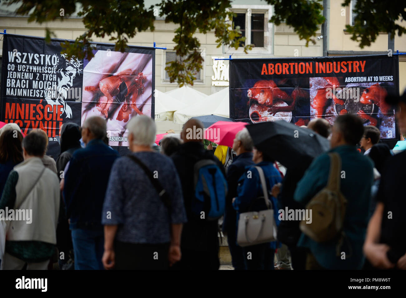 People seen standing next to anti abortion banners during the public Rosary against abortion. A public Rosary at the city center organized by Fundacja Pro, a prolife and anti-abortion association. Fetus deaths due to abortion were prayed for. There was a case of a counter protest from an abortion supporter. Stock Photo