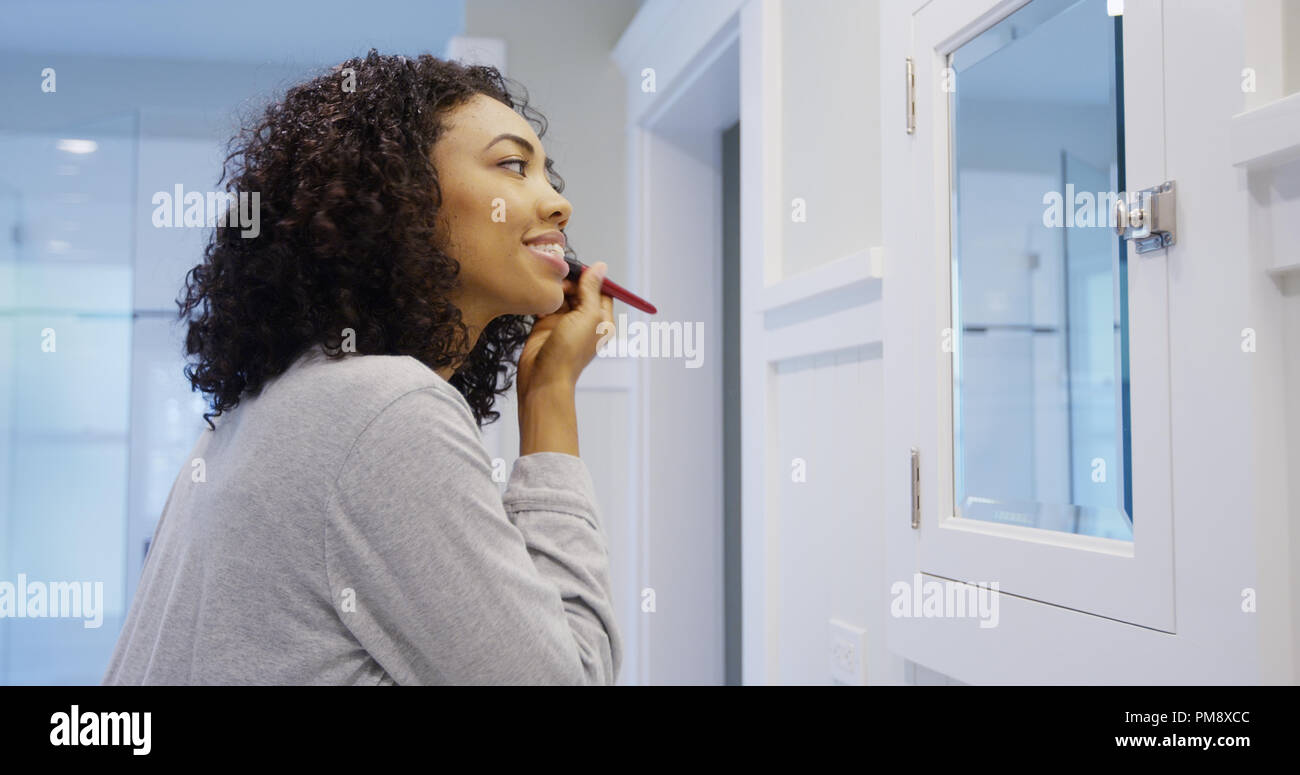 African woman applying foundation hi-res stock photography and images ...