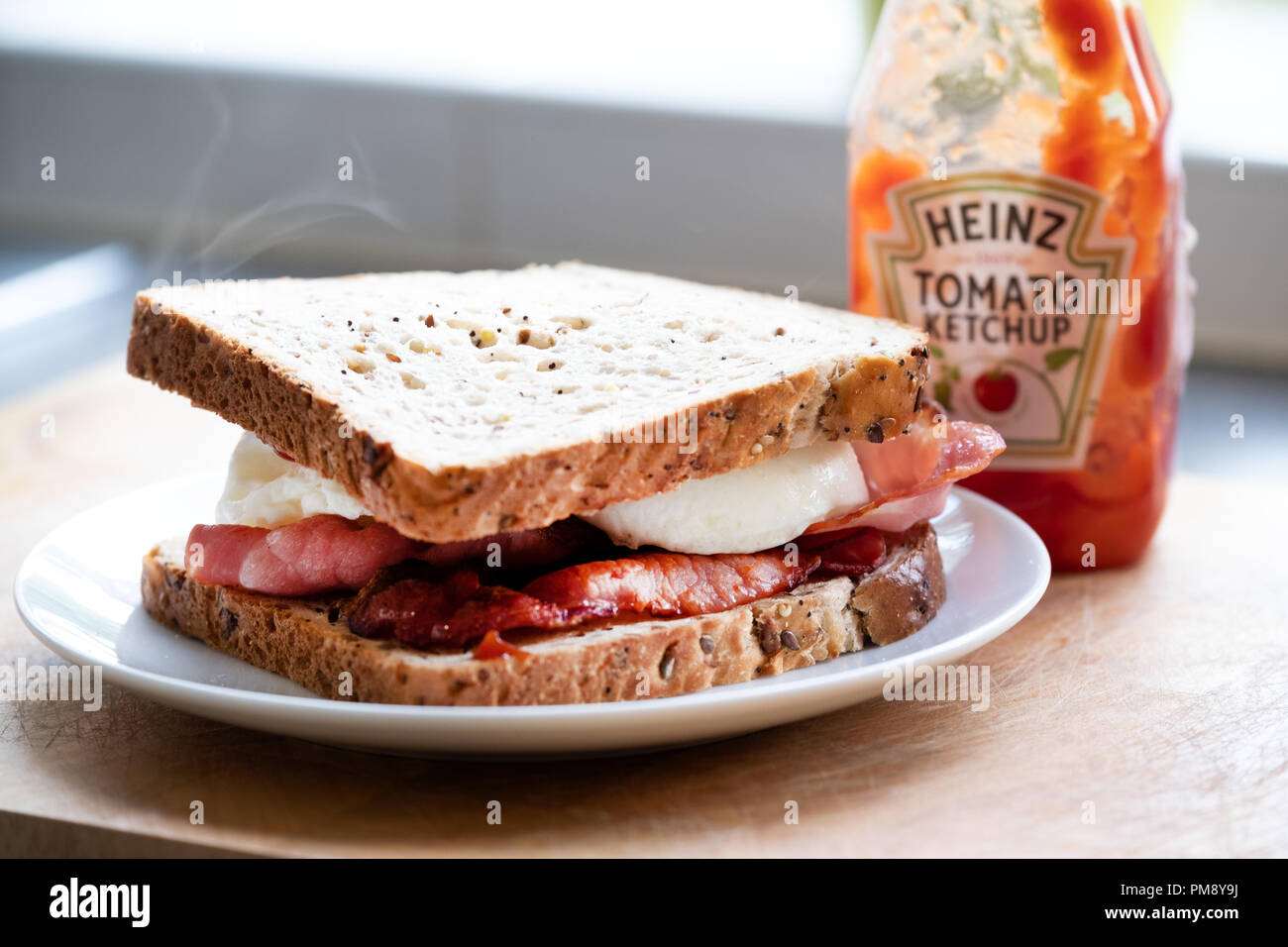 A classic, traditional, delicious, english egg and bacon sandwich made