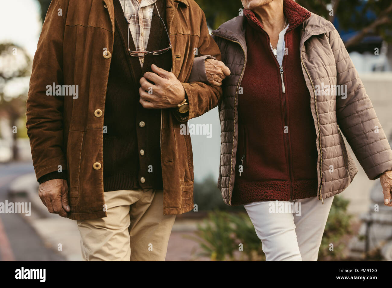 Old couple walking hand in hand hi-res stock photography and images - Alamy