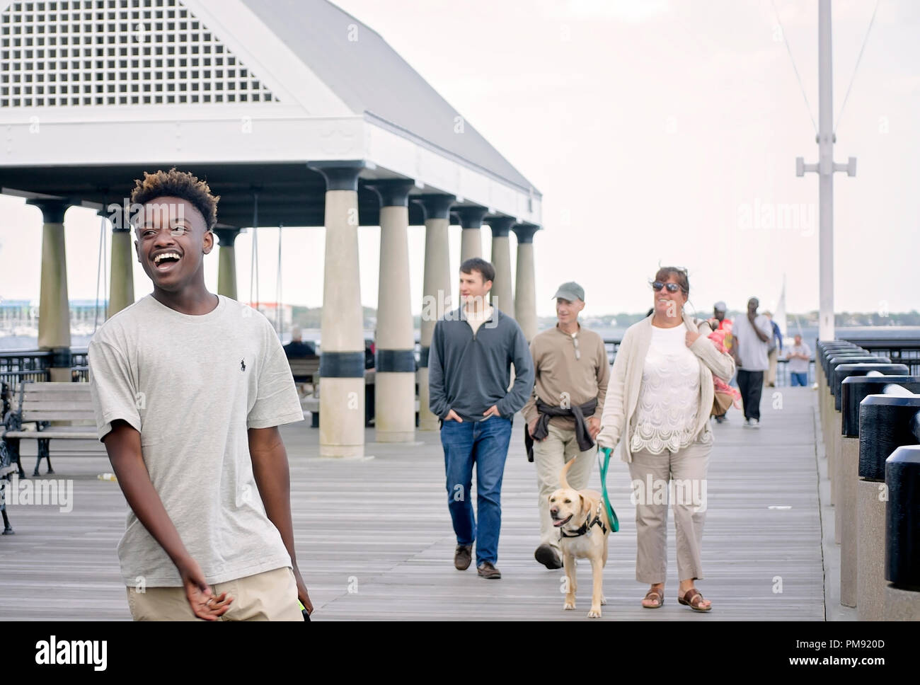 An African-American teenager laughs as he walks down the pier at Waterfront Park, April 5, 2015, in Charleston, South Carolina. Stock Photo