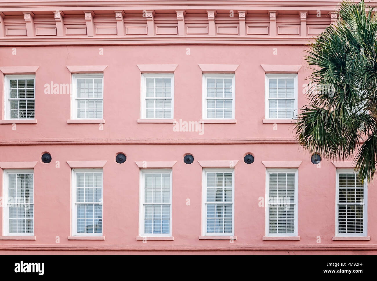 Iron earthquake bolts are covered by round gib plates on the exterior of a restaurant, The Drawing Room, April 5, 2015, in Charleston, South Carolina. Stock Photo