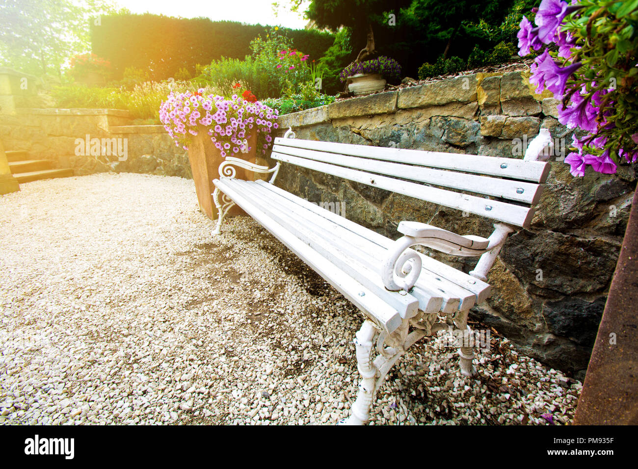 Bench in beautiful green park with flowers. Stock Photo