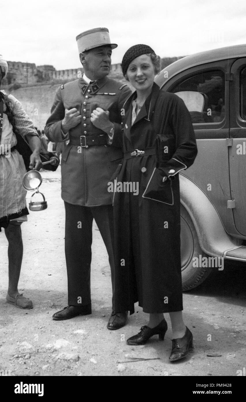Morocco 1930s French Foreign Legion soldier and smartly dressed woman with local man selling goods Stock Photo