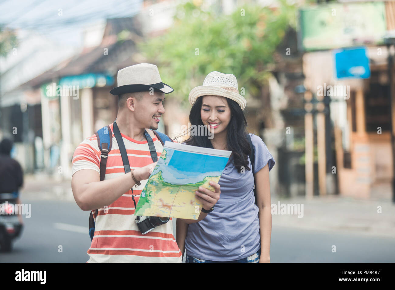 Young Backpackers two young backpackers searching direction on location map while Stock ...