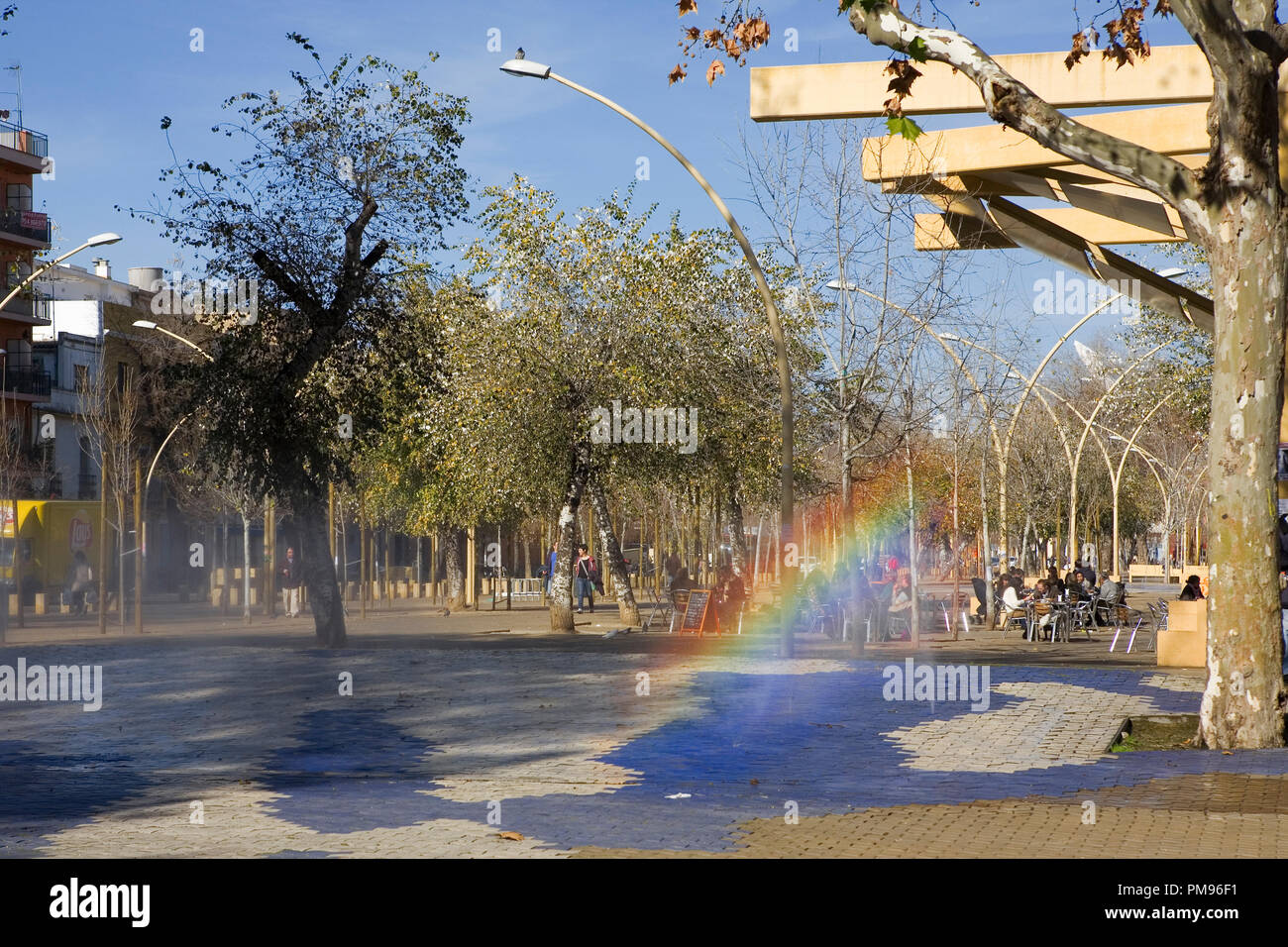 Modern fountain creating a rainbow, La Alameda de Hércules, Sevilla, Andalusia, Spain Stock Photo