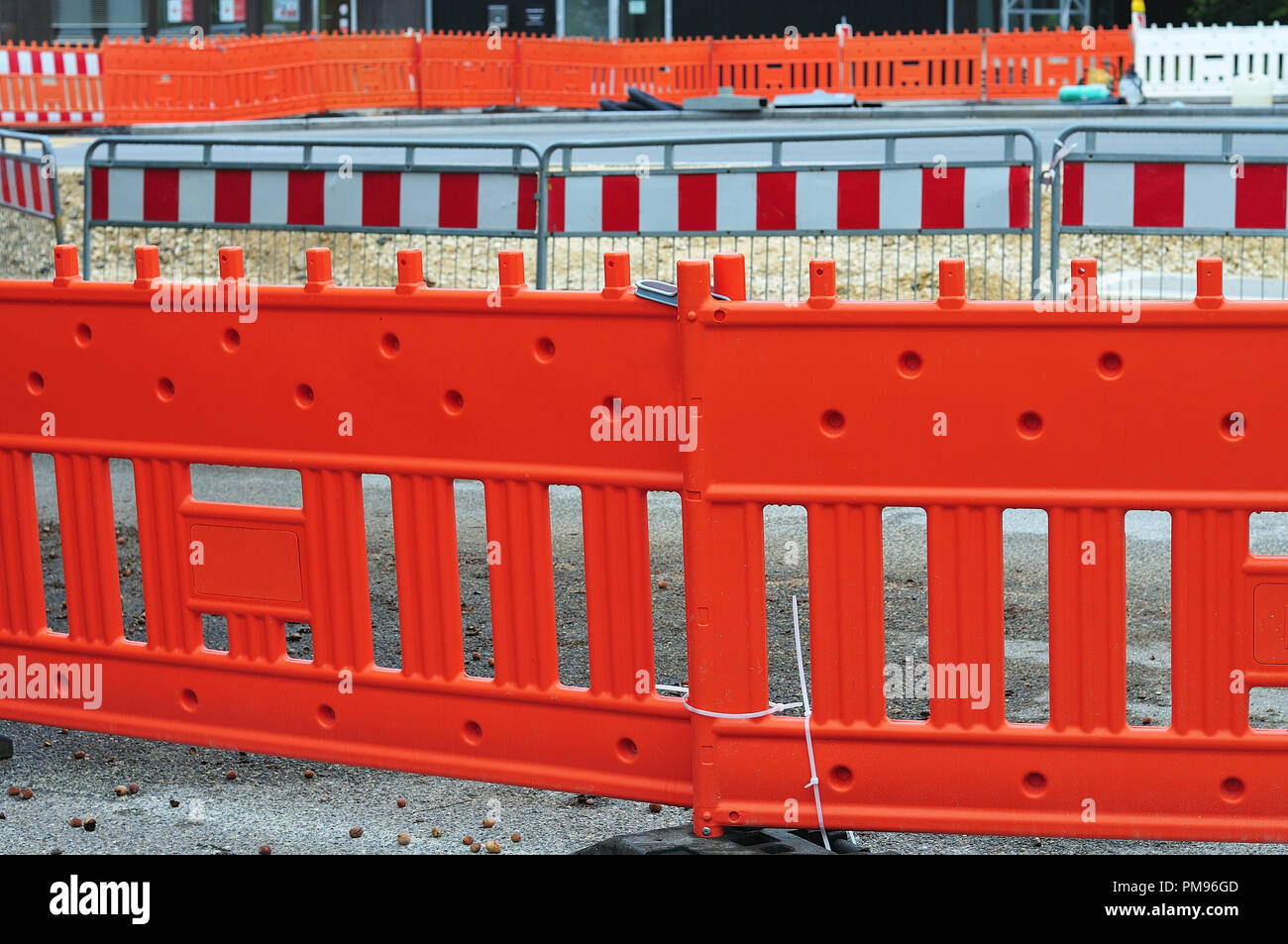 safety barriers at construction site of metal and plastic with red and white stripes Stock Photo