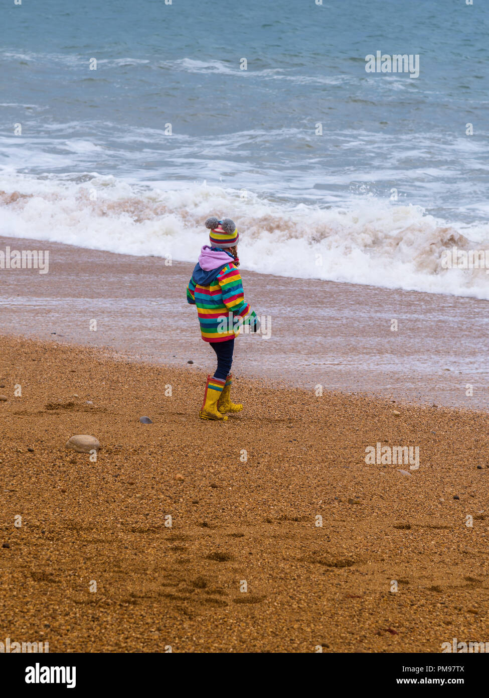 Girl on Hive Beach, Burton Bradstock, Dorset, UK Stock Photo