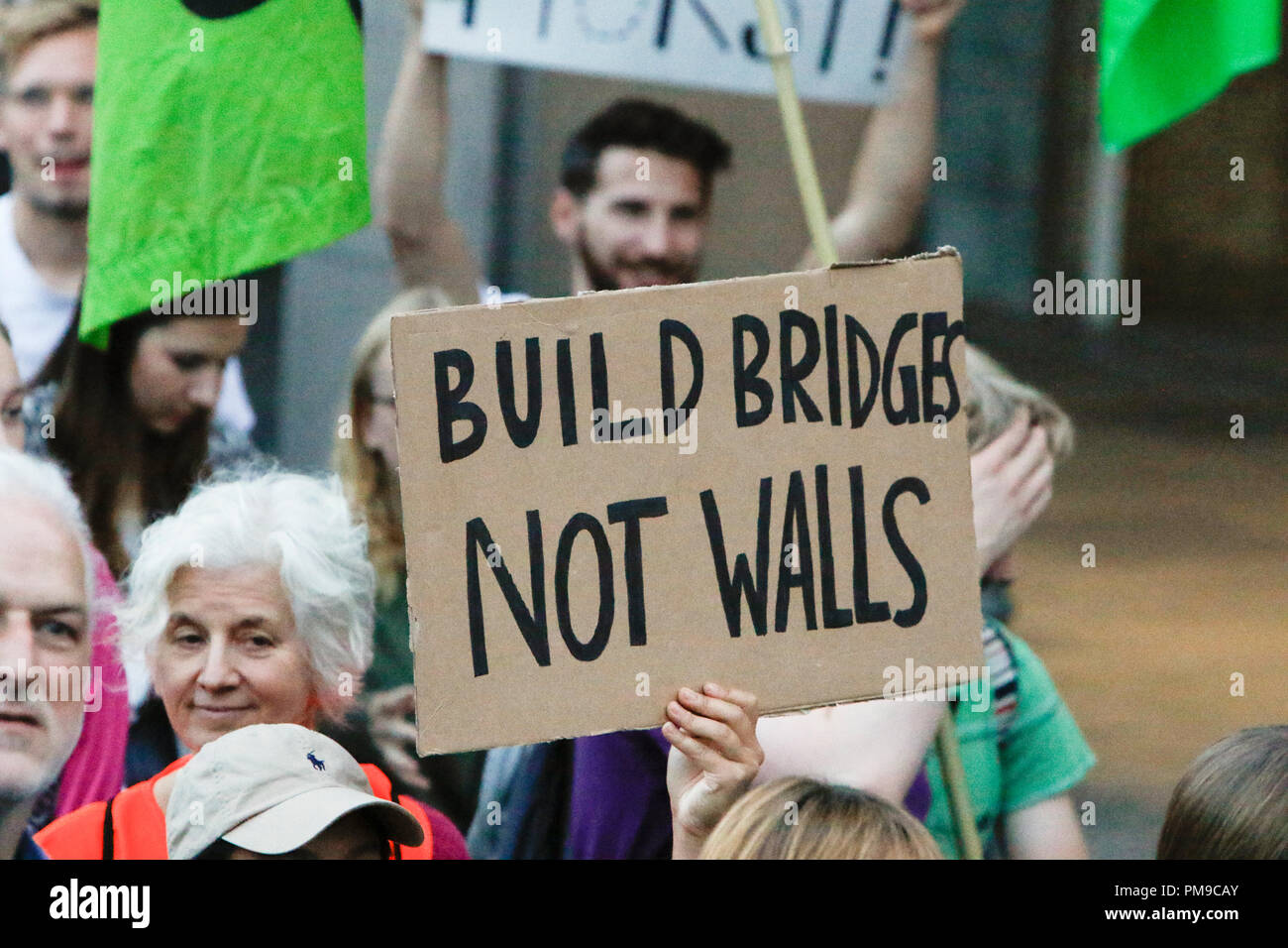 Frankfurt, Germany. 17th September 2018. A protester holds up a sign that reads 'Build bridges not walls'. Around 6.300 protesters marched through Frankfurt, in support of the Seebrucke (Sea Lift) movement for the rescuing of refugees from the Mediterranean Sea. They also protested against the restrictive refugee policies of German Federal Interior Minister Horst Seehofer, who was due to speak at a congress in Frankfurt the following day, but whose appearance was cancelled. Credit: Michael Debets/Alamy Live News Stock Photo