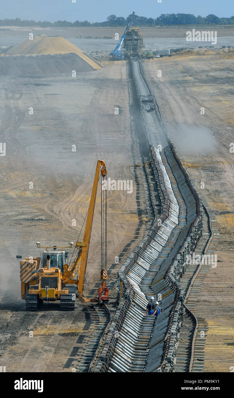 Welzow, Brandenburg. 17th Sep, 2018. Workers move a conveyor belt for overburden in the Welzow South opencast lignite mine of LEAG (Lausitz Energie Bergbau AG). The village of Proschim, only a few kilometres away, is to be dredged for the Welzow South opencast lignite mine. Residents and environmental associations have been defending themselves against this for many years. The Coal Commission will meet again in Berlin on 18.09.2018. Credit: Patrick Pleul/dpa-Zentralbild/ZB/dpa/Alamy Live News Stock Photo